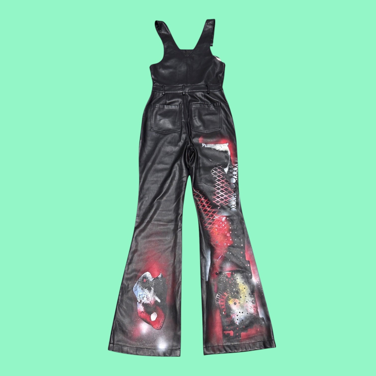 Blue Greenie Forging Armors black faux leather jumpsuit with hand-painted red and metallic geometric patterns.