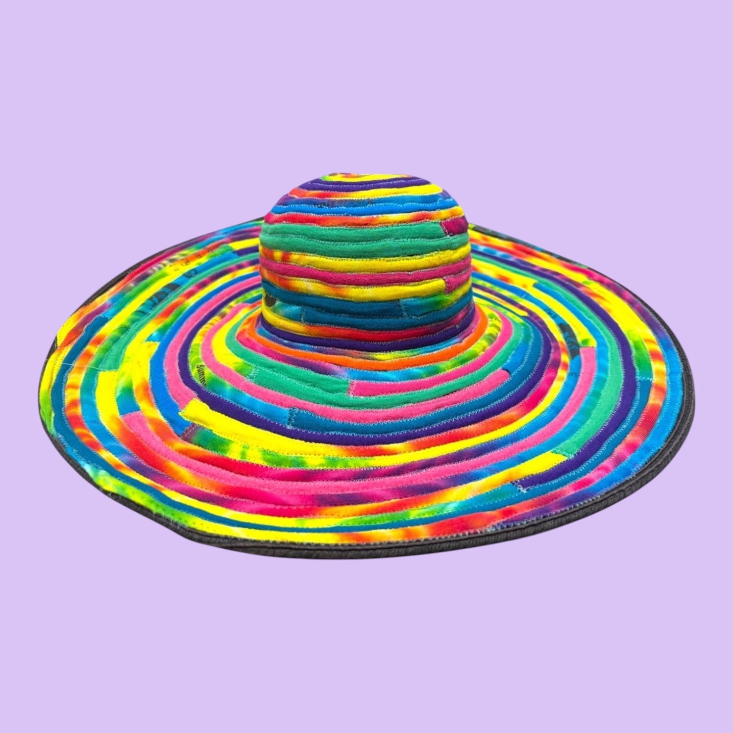 Blue Greenie large brim hat made from colorful tie-dye t-shirt fabric strips in a spiral pattern