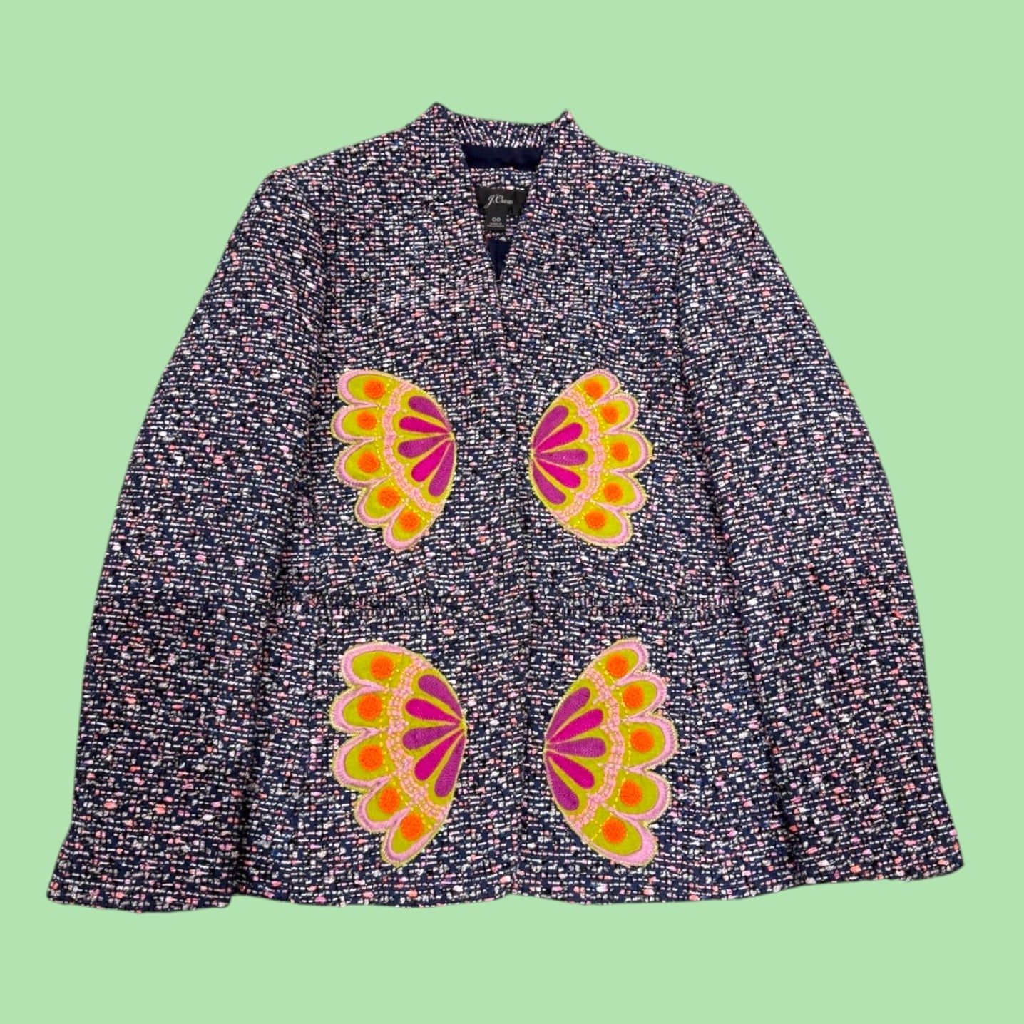 Blue Greenie J. Crew tweed jacket with vibrant pink and green floral appliqué details on a dark textured fabric.