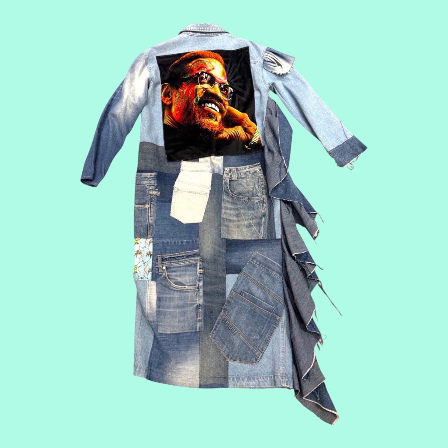 Blue Greenie patchwork denim coat featuring a vibrant Malcolm X graphic print on the back and frayed hem details.