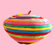 Blue Greenie red wool beret featuring colorful striped t-shirt fabric accents and a small stem detail