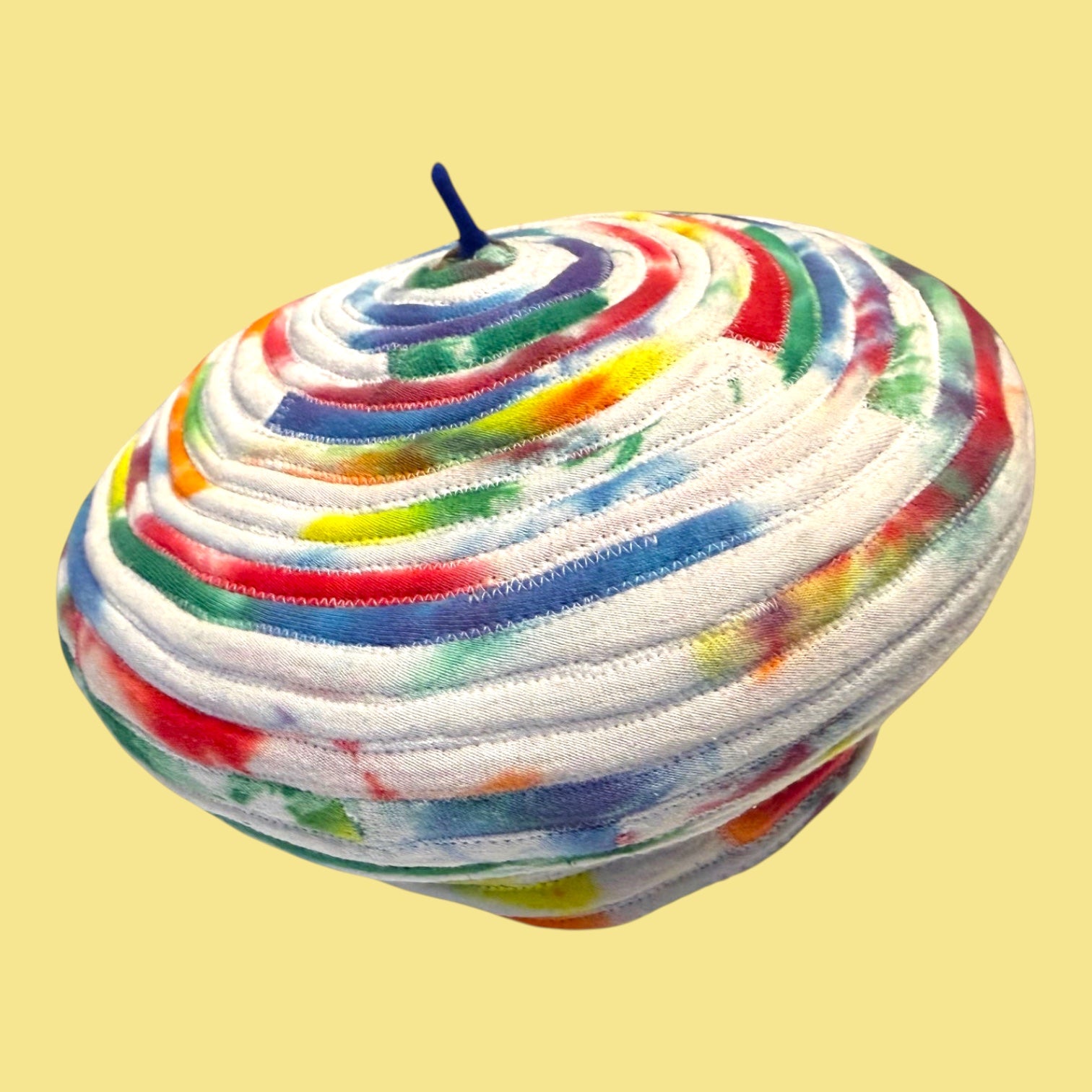 Blue Greenie size L beret crafted from coiled tie-dye t-shirt strips in vibrant multi-colored patterns