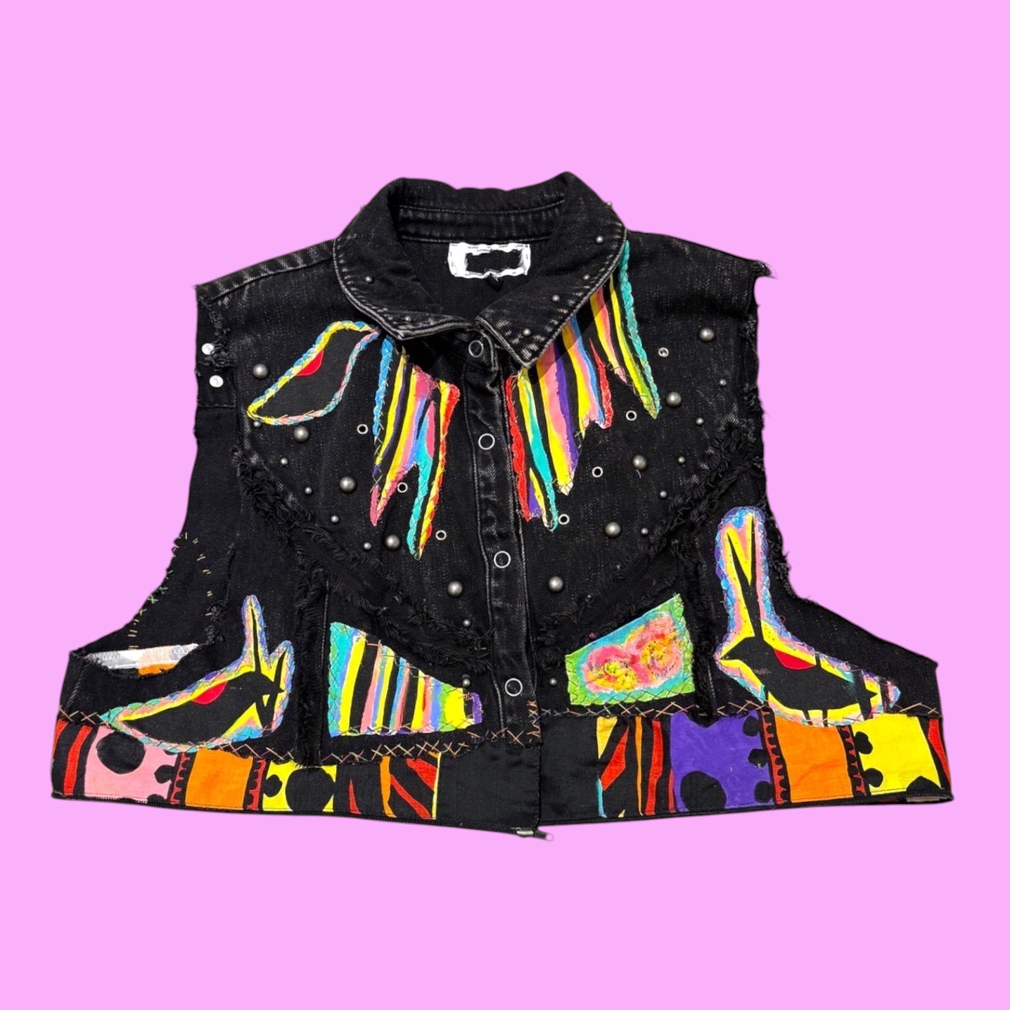 Blue Greenie Eivy T2T upcycled black denim vest with hand-stitched colorful appliqué, paint, and metal studs.